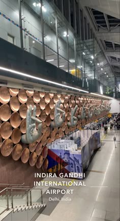 there are many copper pans hanging on the wall in this airport terminal lobby area