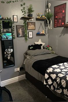 a bedroom decorated for halloween with decorations on the wall and bed in front of it