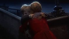 two children hugging each other on the stairs