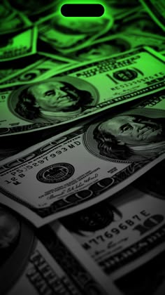 the green light is shining on many dollar bills