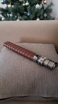 a star wars vader sitting on top of a pillow next to a christmas tree