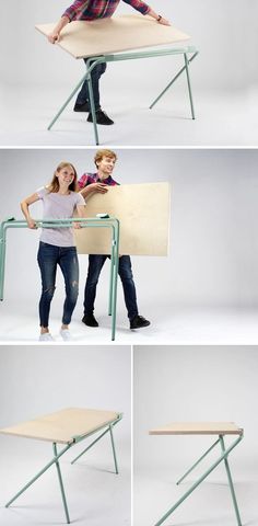two people are standing behind a table that is made out of plywood