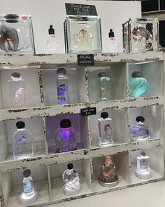 an assortment of perfume bottles on display in a store