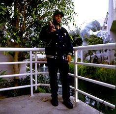 a man standing on a bridge pointing at the camera