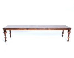 a wooden table sitting on top of a white floor