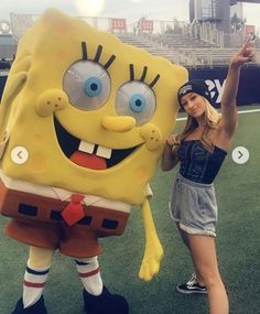 a woman standing next to a spongebob mascot