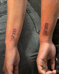 two people holding hands with tattoos on their arms that say, good and bad to each other