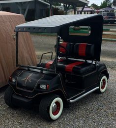an old fashioned golf cart is parked on the gravel