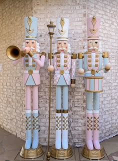 two nutcrackers are standing next to each other in front of a brick wall