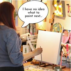 a woman holding a paintbrush in front of an easel with a thought bubble above it