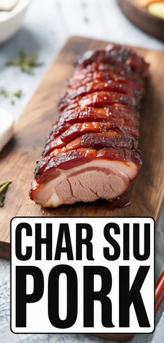 a wooden cutting board topped with sliced meat