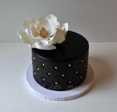 a black and white cake with a flower on top