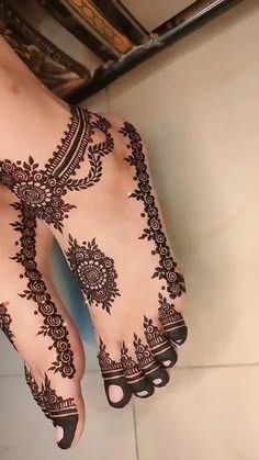the feet are decorated with henna designs