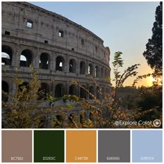 the sun is setting in front of an old roman colossion with many windows
