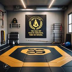a gym with black and yellow flooring and an emblem on the wall above it