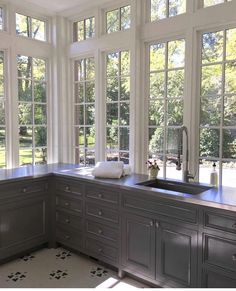 a kitchen with lots of windows and cabinets