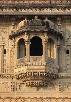 an intricately carved building with windows and balconies