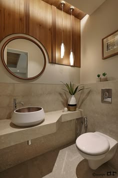 a bathroom with a toilet, sink and mirror on the wall next to each other
