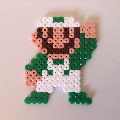 a piece of art made to look like an old school video game character with green and white colors