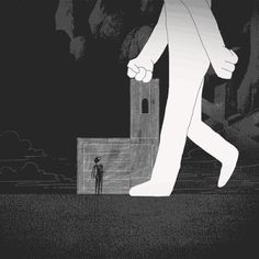 a man walking past a tall building in the dark