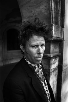 a black and white photo of a man with curly hair