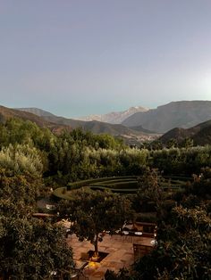 an outdoor seating area with mountains in the background