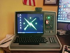 an open laptop computer sitting on top of a wooden desk