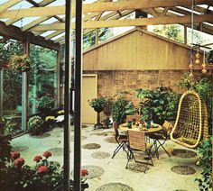 an outdoor patio with chairs, tables and potted plants