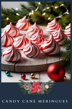 candy cane meringues on a wooden board surrounded by christmas decorations