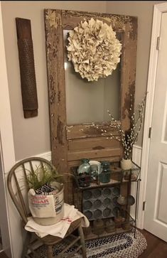 a room with a chair, mirror and potted plant