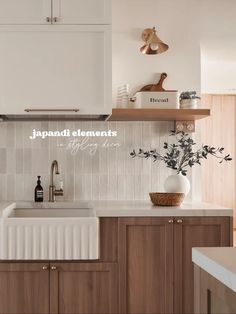 a kitchen with wooden cabinets and white tile backsplash, wood shelfs above the sink
