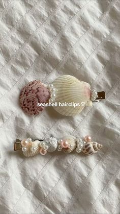three seashell hair clips on a white sheet