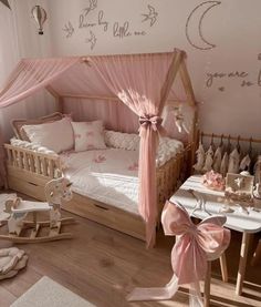 a child's bedroom decorated in pink and white