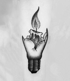 a black and white photo of a light bulb tattoo