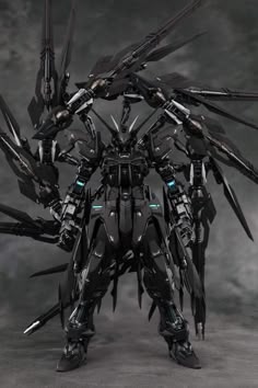 a black and white photo of a robot like figure with spikes on it's head