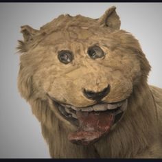 a stuffed lion head with its tongue out