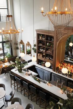 the bar is decorated with plants and hanging lights