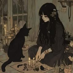 a woman sitting on the floor next to a black cat with candles in front of her