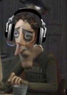 a man wearing headphones and holding a computer mouse