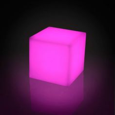 an illuminated cube on a black background