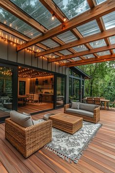 a wooden deck with wicker furniture and string lights on the ceiling is lit by outdoor lighting