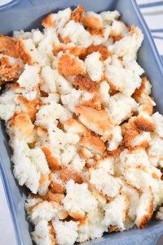 a blue dish filled with food on top of a table
