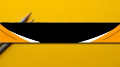 two pencils sitting on top of a piece of paper with black and yellow stripes