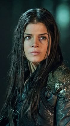 a woman with long hair and leather jacket