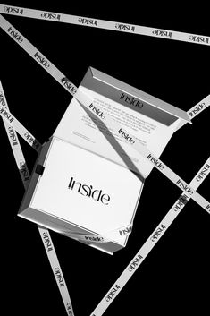 a piece of paper sitting on top of a pile of white tape with the word inside it