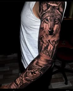 a man's arm with a wolf and castle tattoo on the left sleeve, which is