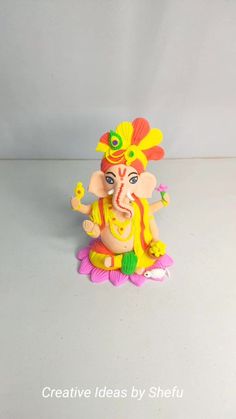 an elephant statue sitting on top of a white table