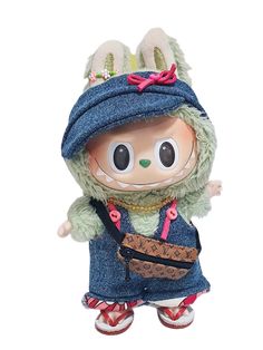 a small stuffed animal wearing a blue outfit