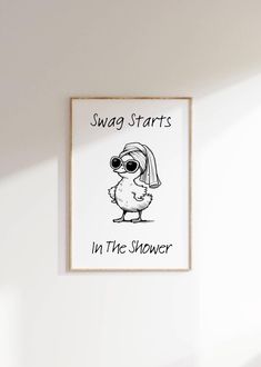 a white wall with a black and white drawing of a chicken wearing sunglasses saying swag starts in the shower