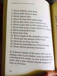 an open book with some writing on it and someone holding the book in their hand